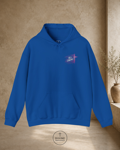 Blue hoodie with a logo on the chest against a beige wall.