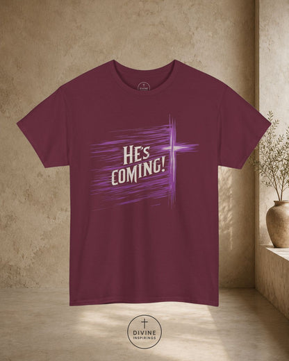 Maroon t-shirt with 'HE'S COMING!' text on a beige background