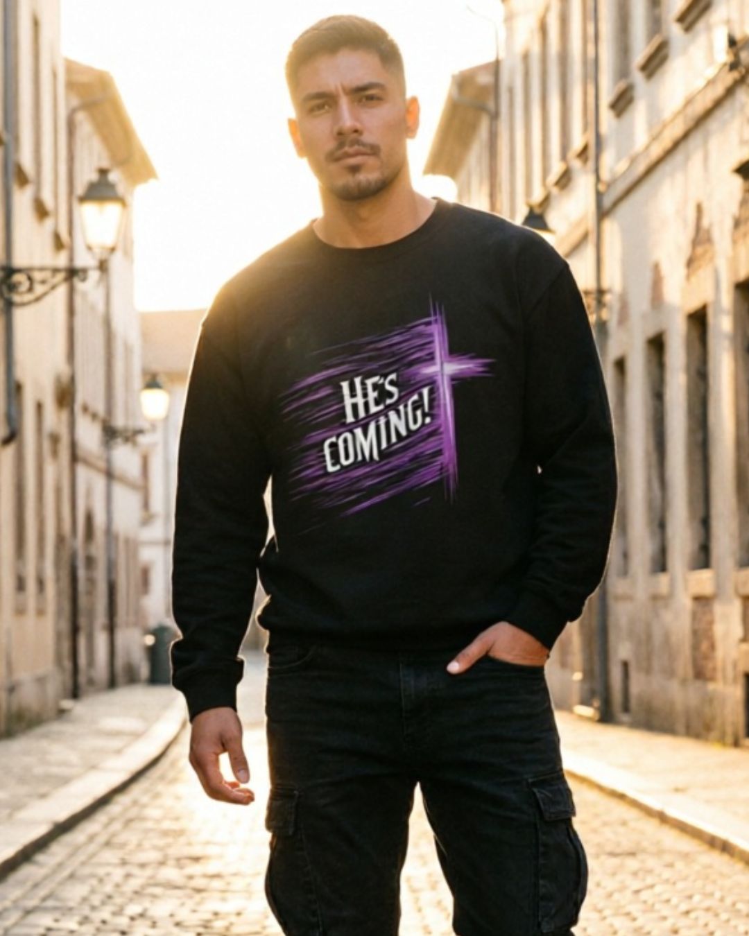 Man wearing a black sweatshirt with purple text on a street.
