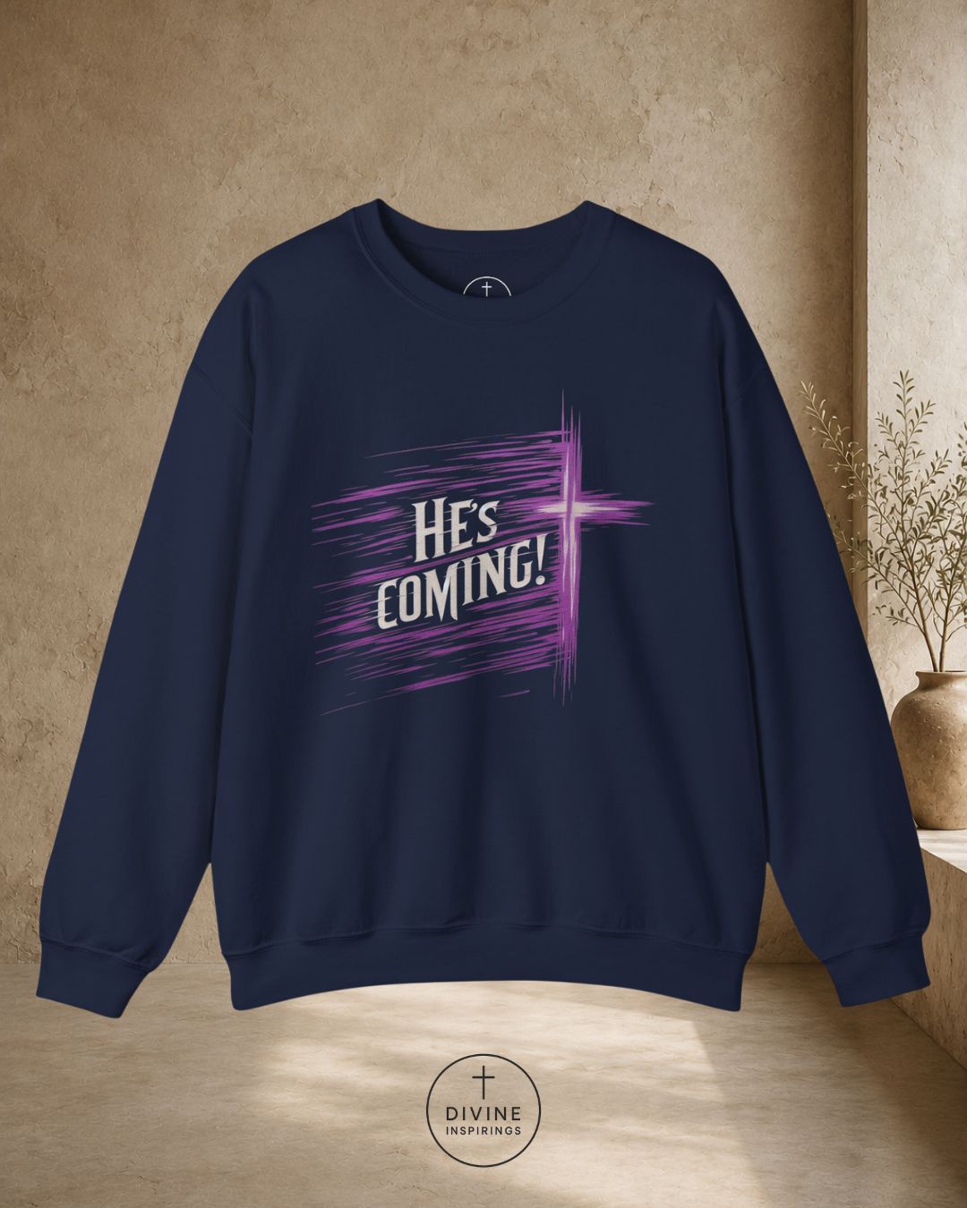Navy blue sweatshirt with 'He's Coming!' text on a beige background