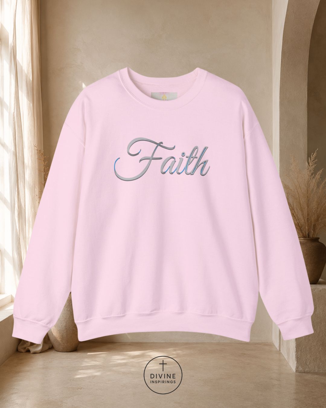 Pink sweatshirt with 'Faith' text in a room with natural light