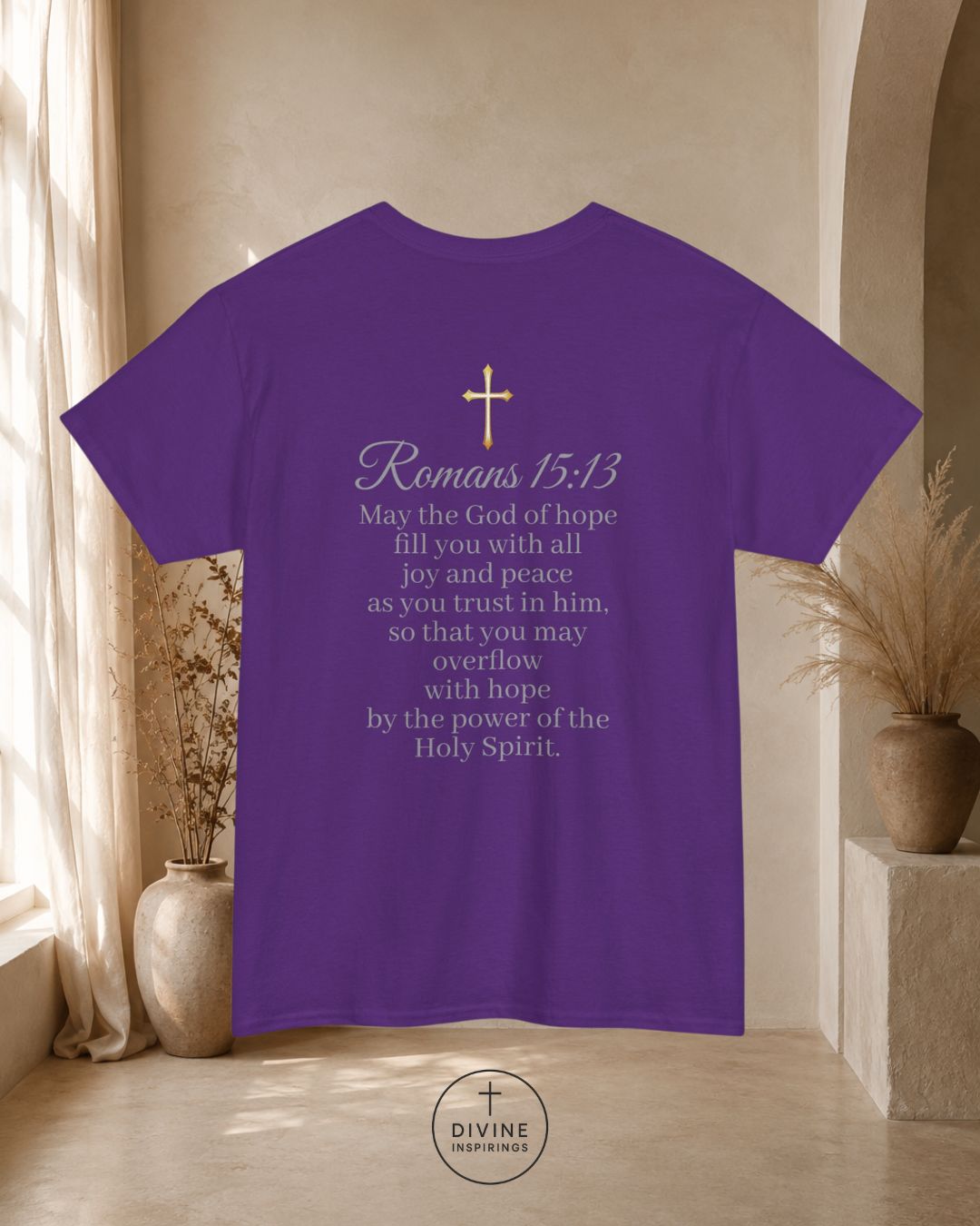 Purple t-shirt with text and cross design on the back, displayed in a room with decor elements.
