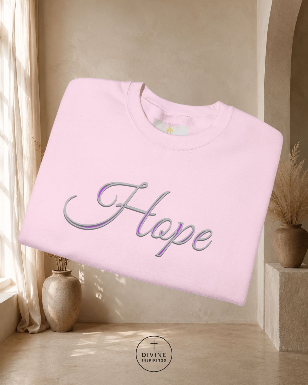 Pink sweatshirt with 'Faith' embroidery in a home setting