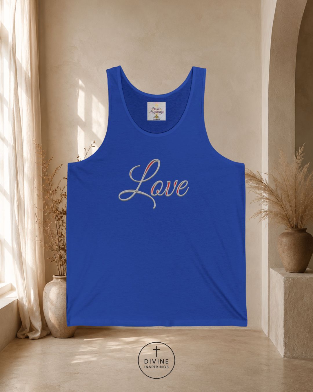 Blue tank top with 'Faith' printed on it in a room with natural light