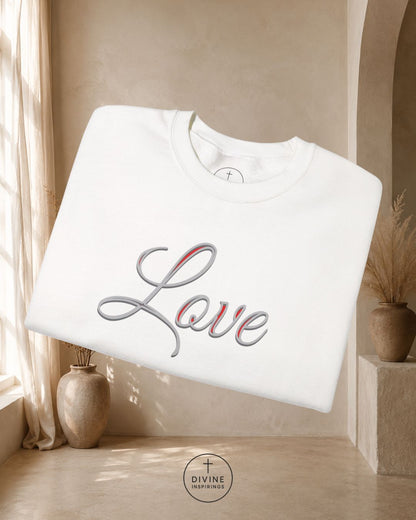 White sweatshirt with 'Love' design in a room with beige walls and decor.