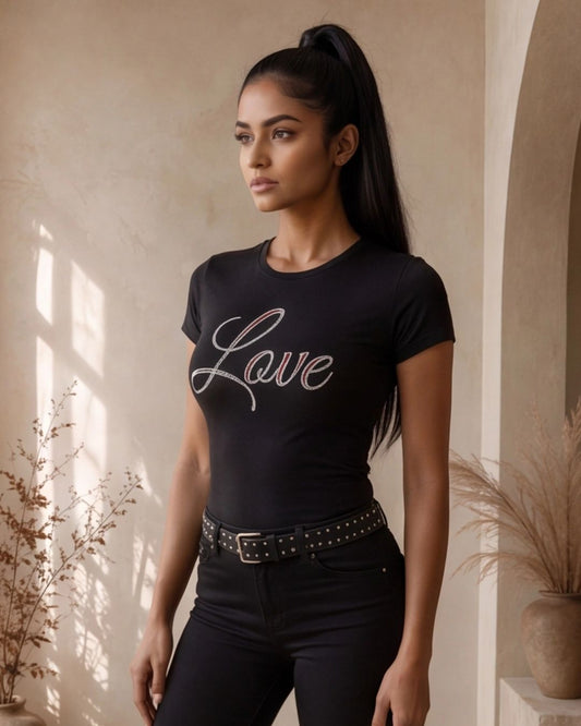 Woman wearing a black t-shirt with 'Love' printed on it in a sunlit room.