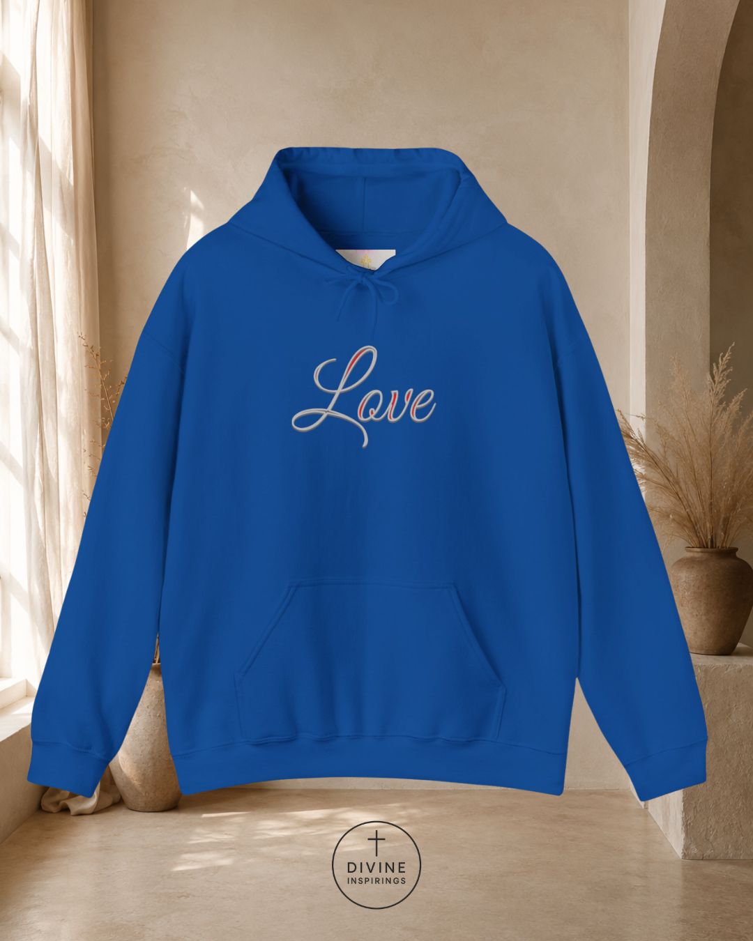 Blue hoodie with 'Love' text on a neutral background