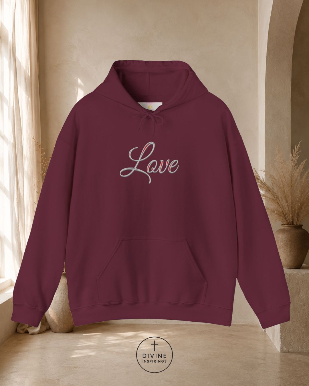 Maroon hoodie with 'Love' text on a neutral background