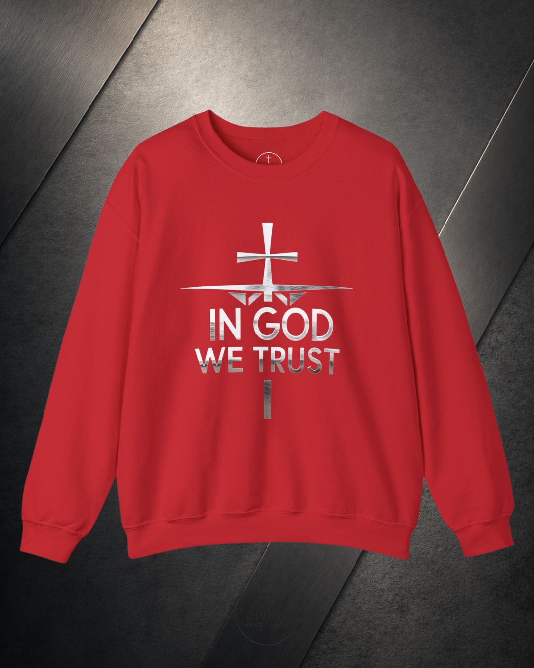 Red sweatshirt with 'In God We Trust' text and cross design on a dark surface