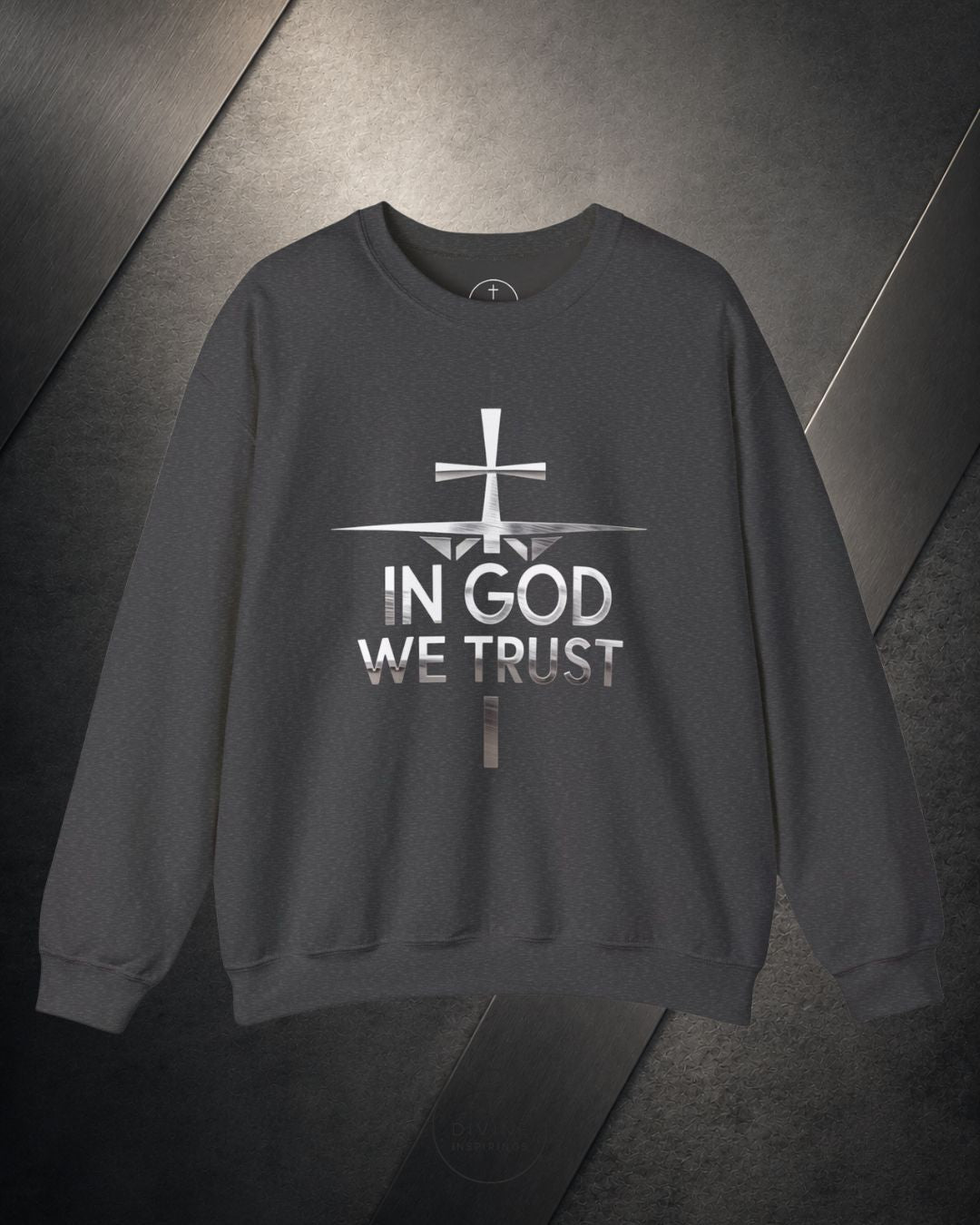 Gray sweatshirt with 'In God We Trust' text and cross design on a dark background