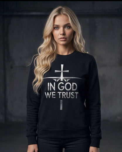 Woman wearing a black sweatshirt with 'IN GOD WE TRUST' text on a dark background