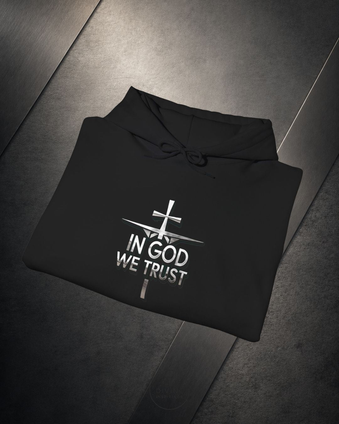 Black hoodie with 'In God We Trust' text on a dark surface