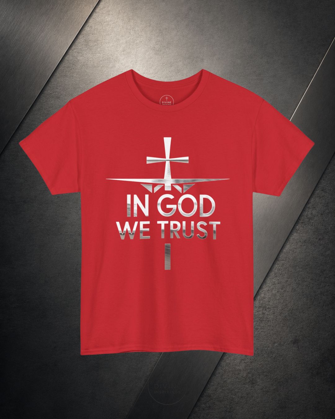 Red t-shirt with 'In God We Trust' text and cross design on a dark surface