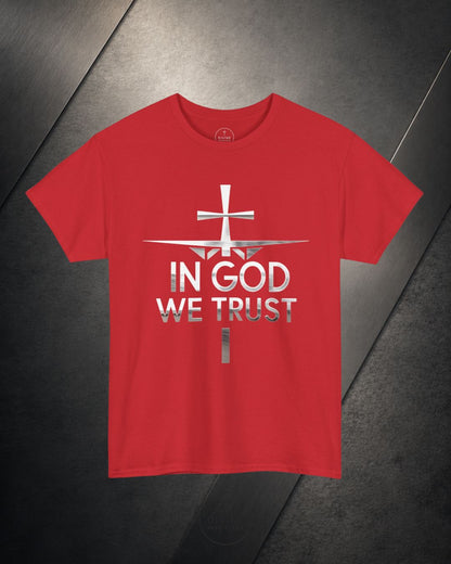 Red t-shirt with 'In God We Trust' text and cross design on a dark surface