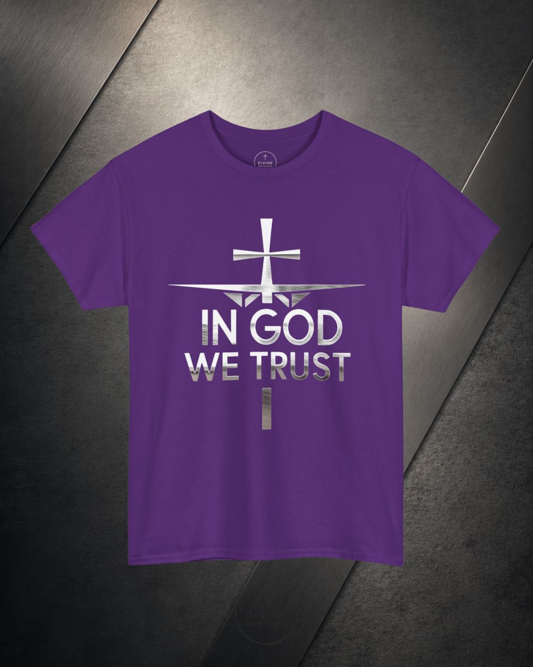 Purple t-shirt with 'In God We Trust' text and cross design on a dark surface