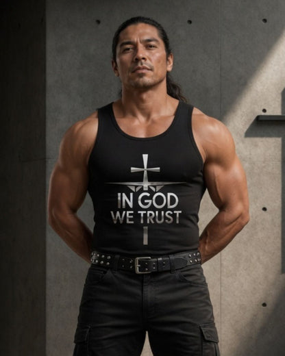 Man wearing a black tank top with 'In God We Trust' text against a gray background