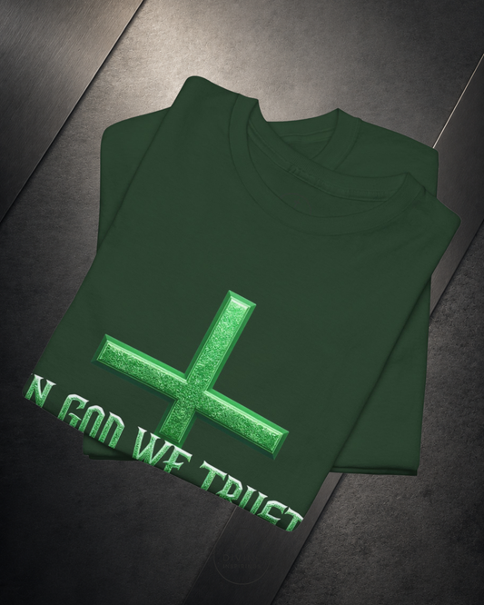 Green shirt with a cross and 'IN GOD WE TRUST' text on a reflective surface