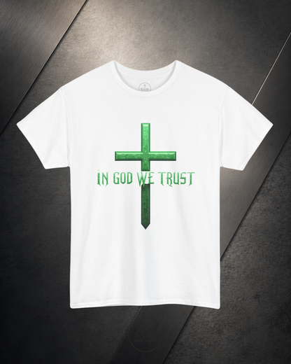 White t-shirt with green cross and 'In God We Trust' text on a dark surface