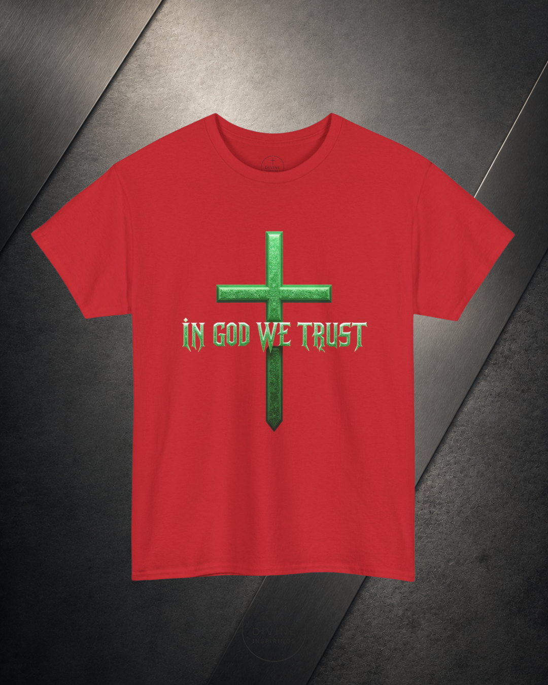 Red t-shirt with green cross and 'In God We Trust' text on a dark surface