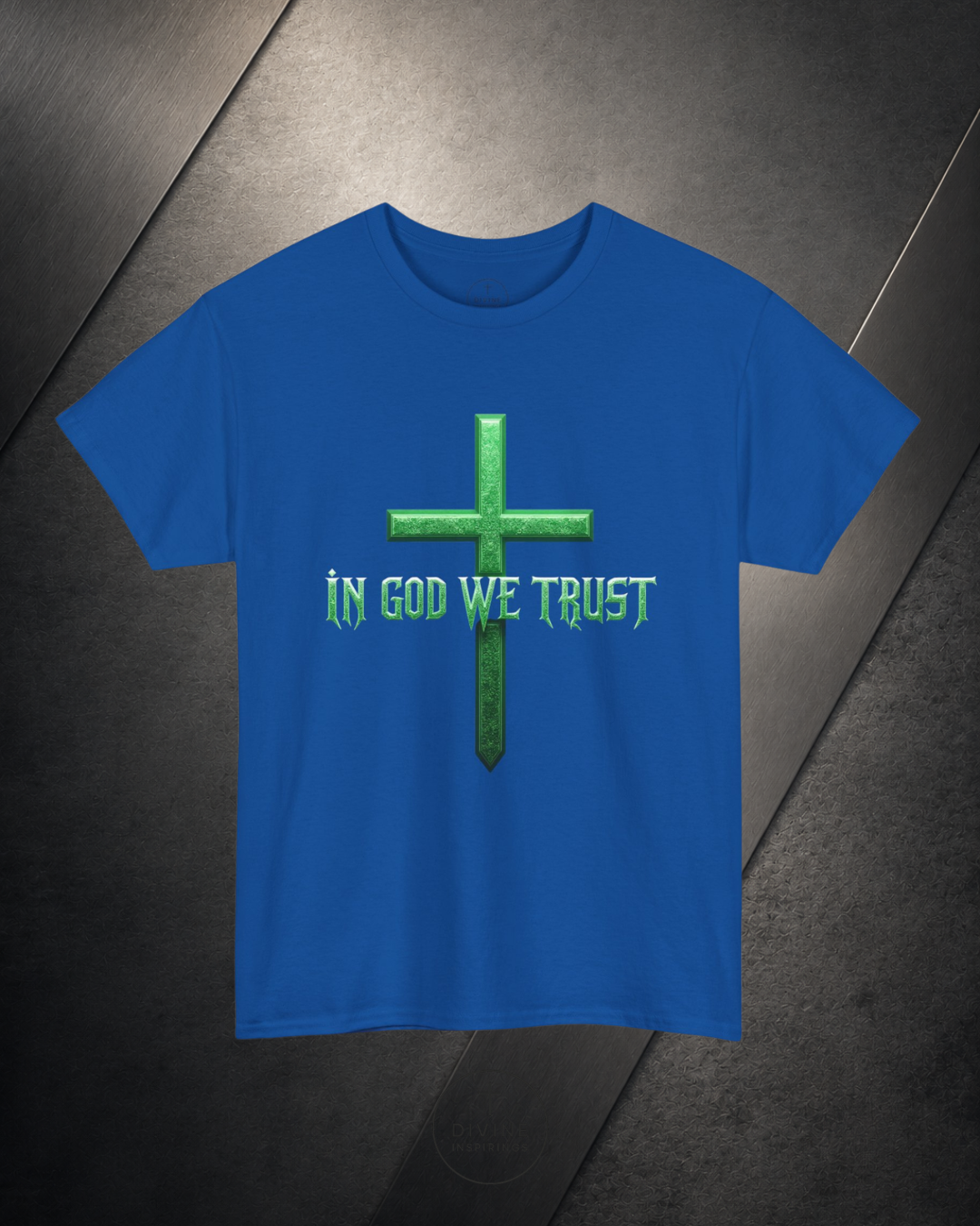 Blue t-shirt with green cross and 'IN GOD WE TRUST' text on a dark surface