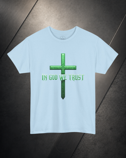 Light blue t-shirt with green cross and 'IN GOD WE TRUST' text on a dark surface