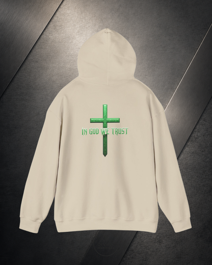 Beige hoodie with green cross and 'IN GOD WE TRUST' text on a dark background