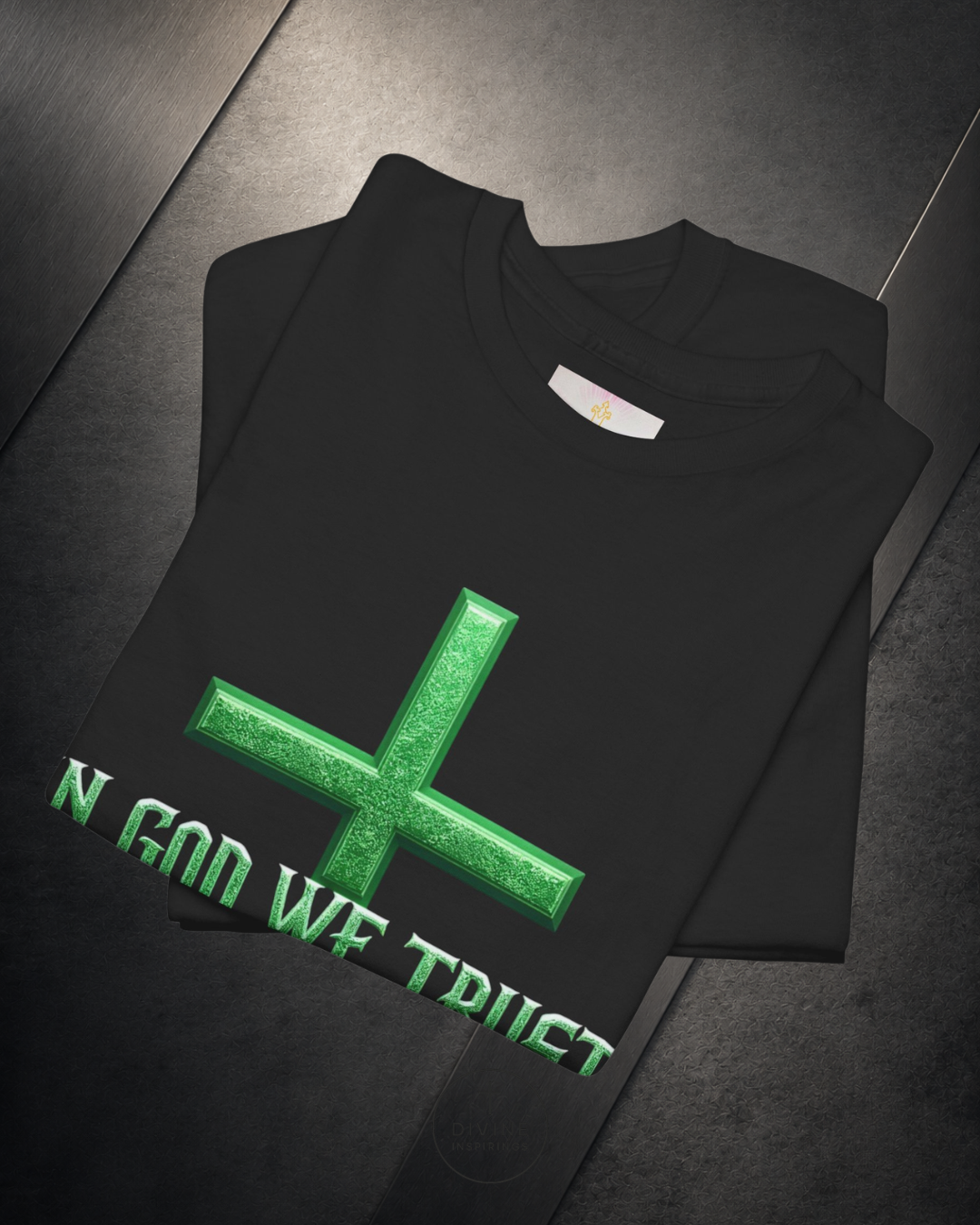 Black sweatshirt with green cross and text on a dark surface