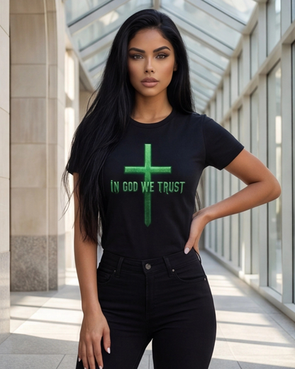 Woman wearing a black t-shirt with a green cross and 'IN GOD WE TRUST' text in an indoor setting.