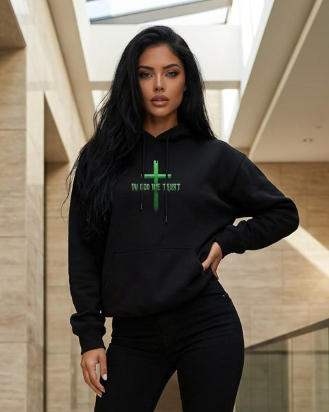 Woman wearing a black hoodie with green text in an indoor setting