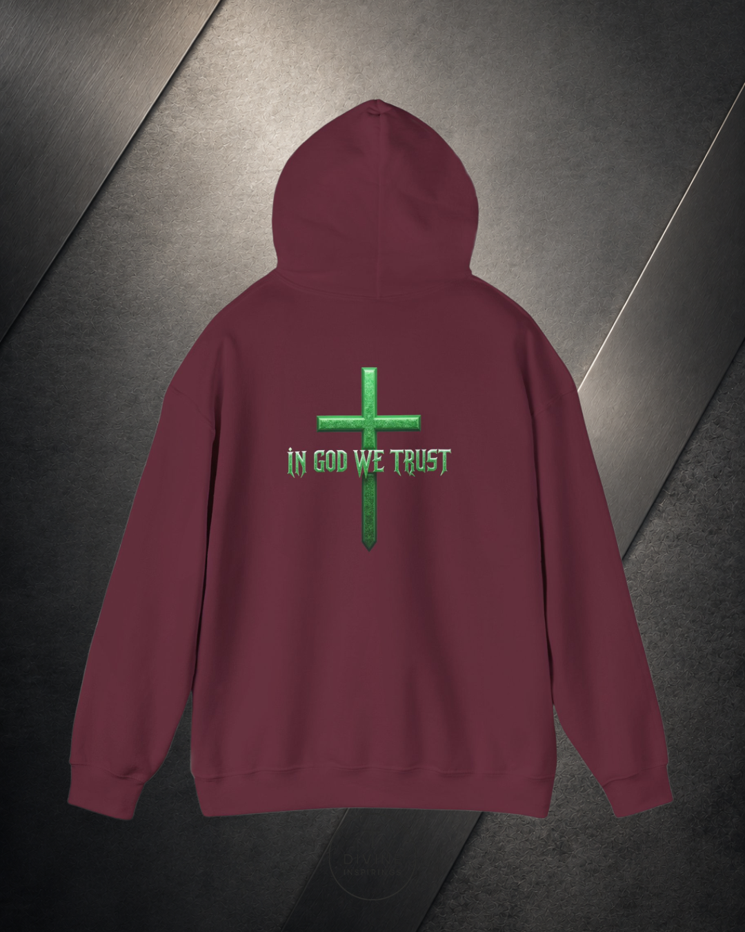 Maroon hoodie with green cross and 'In God We Trust' text on a dark surface