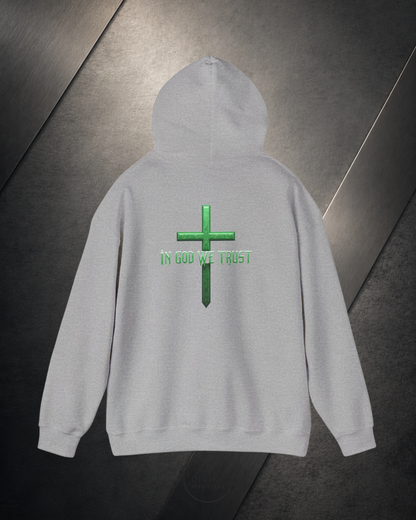Gray hoodie with green cross and 'IN GOD WE TRUST' text on a dark background