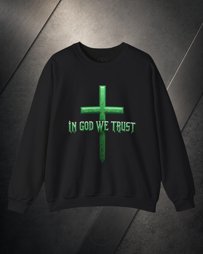 Black sweatshirt with green cross and 'IN GOD WE TRUST' text on a dark background