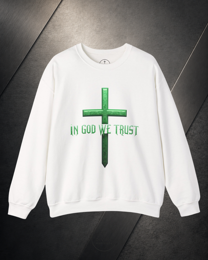 White sweatshirt with green cross and 'IN GOD WE TRUST' text on a dark background