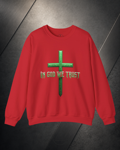 Red sweatshirt with a green cross and 'In God We Trust' text on a dark surface
