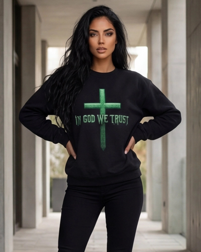 Woman wearing a black sweatshirt with 'IN GOD WE TRUST' printed on it in an urban setting.