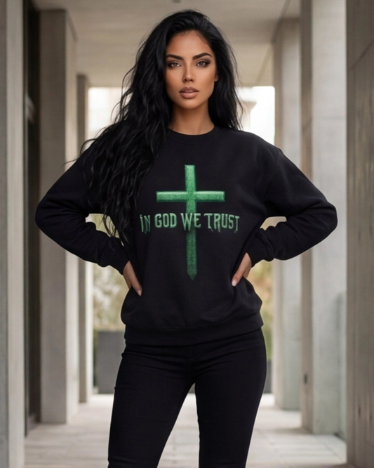 Woman wearing a black sweatshirt with 'IN GOD WE TRUST' printed on it in an urban setting.