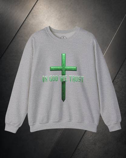 Gray sweatshirt with green cross and 'IN GOD WE TRUST' text on a metallic surface