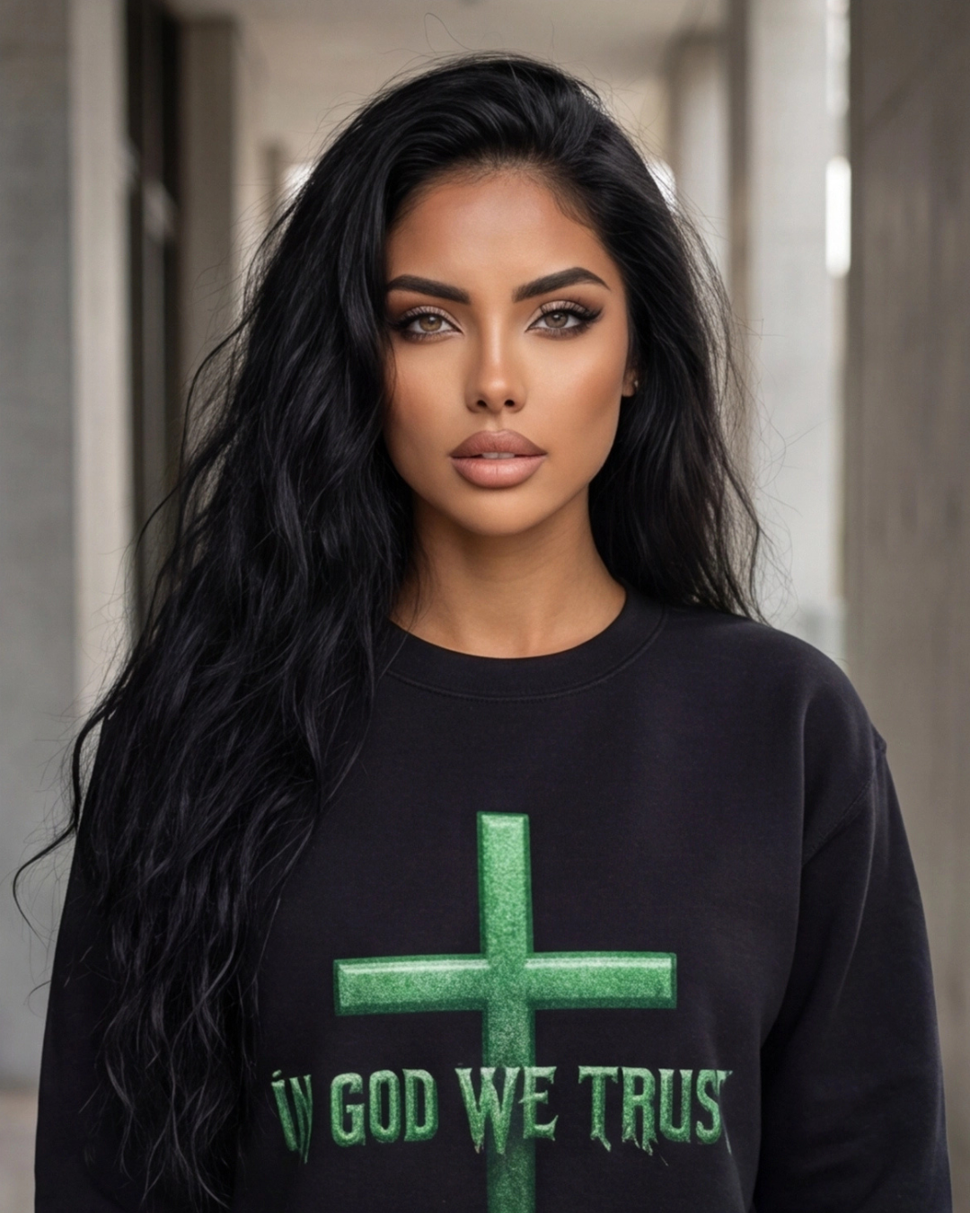 Woman wearing a black sweatshirt with a green cross and 'IN GOD WE TRUST' text.