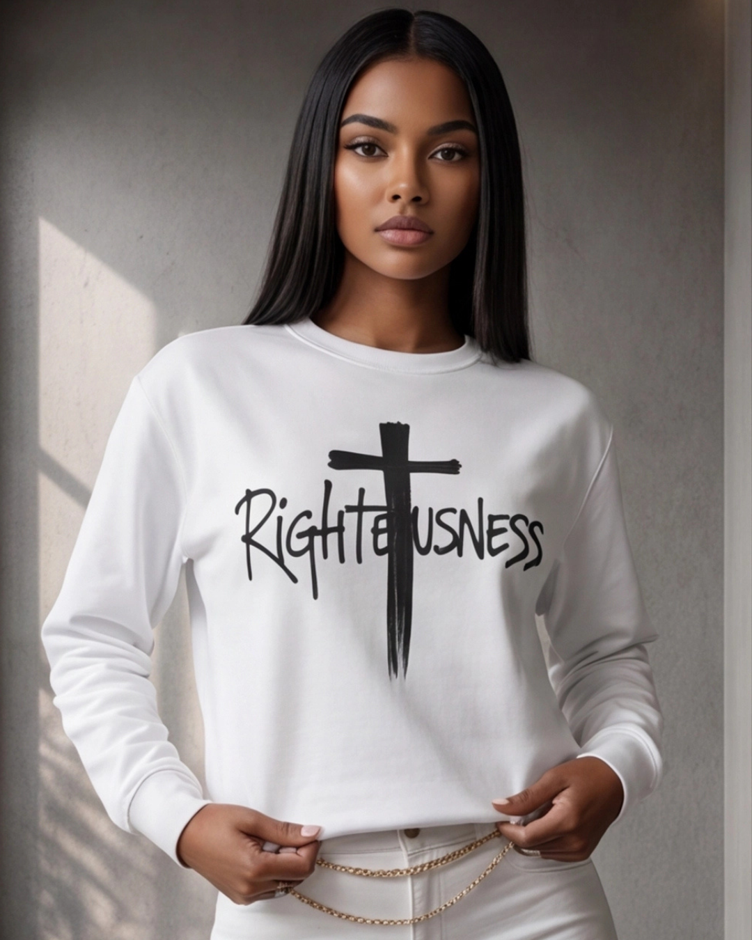 Woman wearing a white sweatshirt with 'Righteousness' text and cross design.