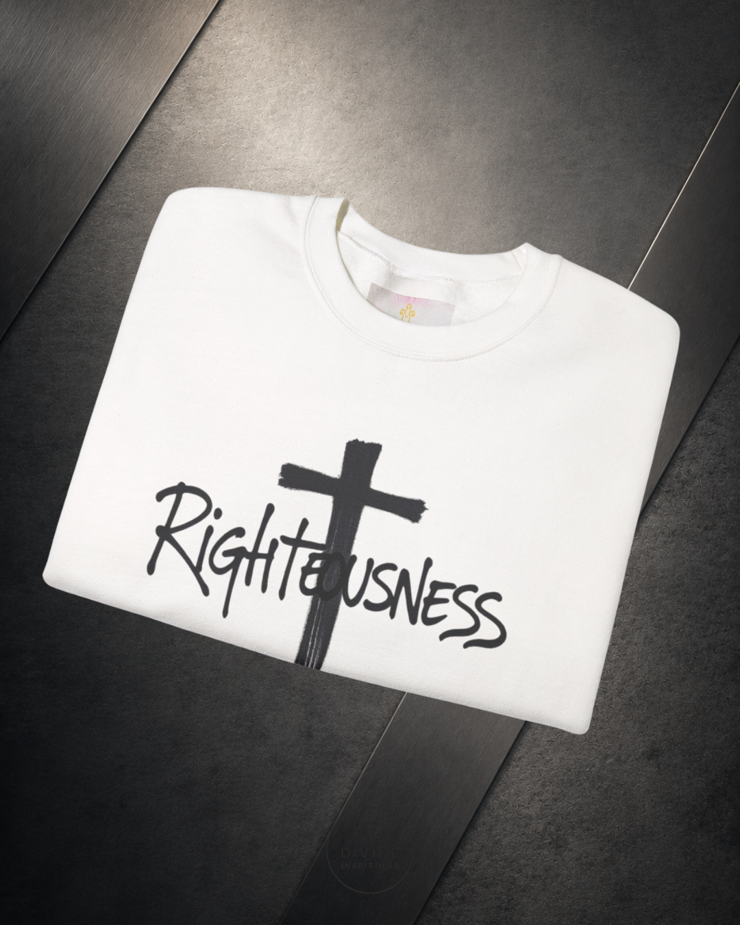 White t-shirt with a black cross and 'Righteousness' text on a dark surface