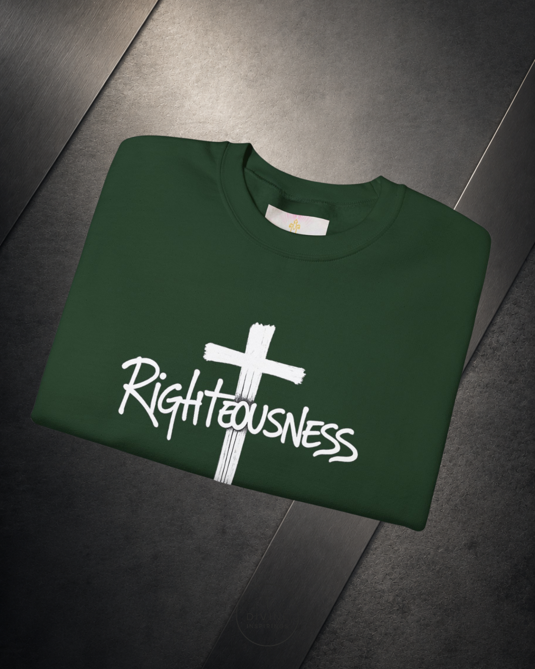 Green sweatshirt with a white cross and 'Righteousness' text on a dark surface