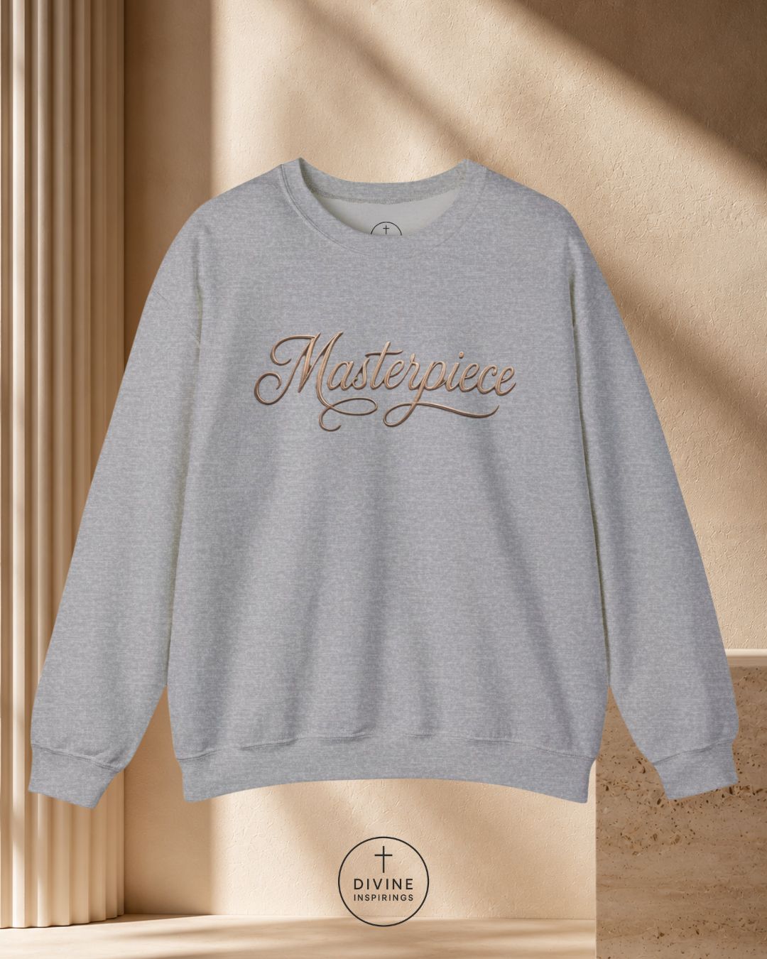 Gray sweatshirt with 'Masterpiece' text on a beige background