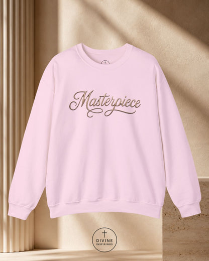 White sweatshirt with 'Masterpiece' text on a beige background