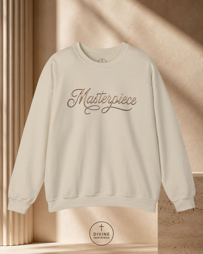 Beige sweatshirt with 'Masterpiece' text on a beige background
