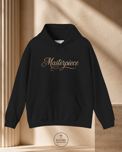 Black hoodie with 'Masterpiece' text on a beige background