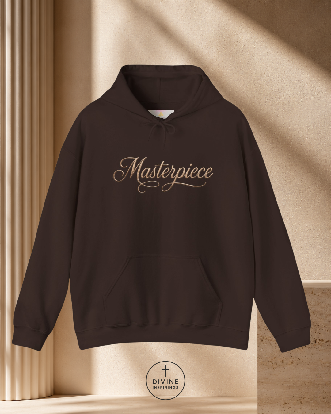 Black hoodie with 'Masterpiece' text on a beige background