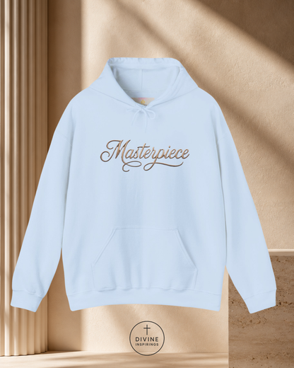 Light blue hoodie with 'Masterpiece' text on a beige background