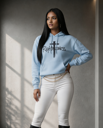 Woman wearing a light blue hoodie with 'Righteousness' text, standing against a neutral wall.