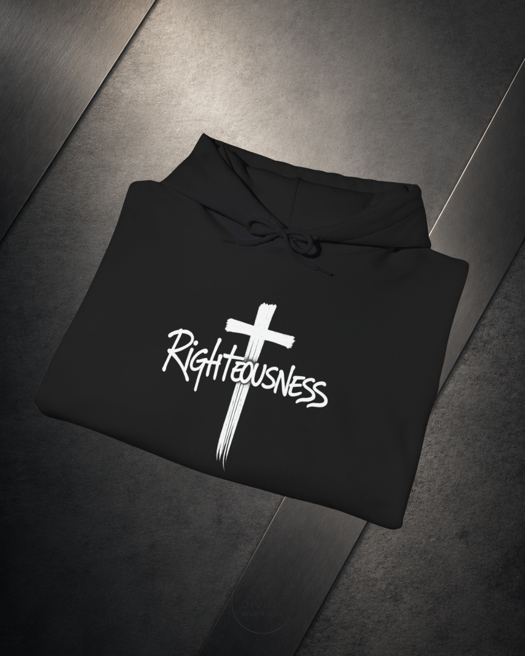 Black hoodie with a white cross and 'Righteousness' text on a dark surface