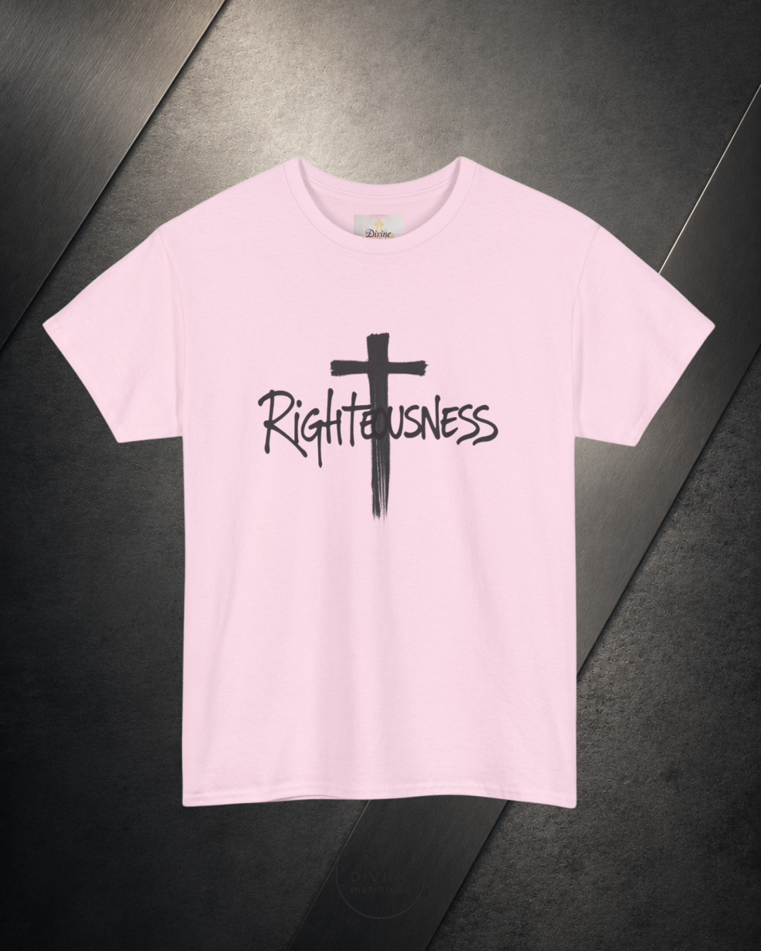 Pink t-shirt with a black cross and 'Righteousness' text on a dark surface